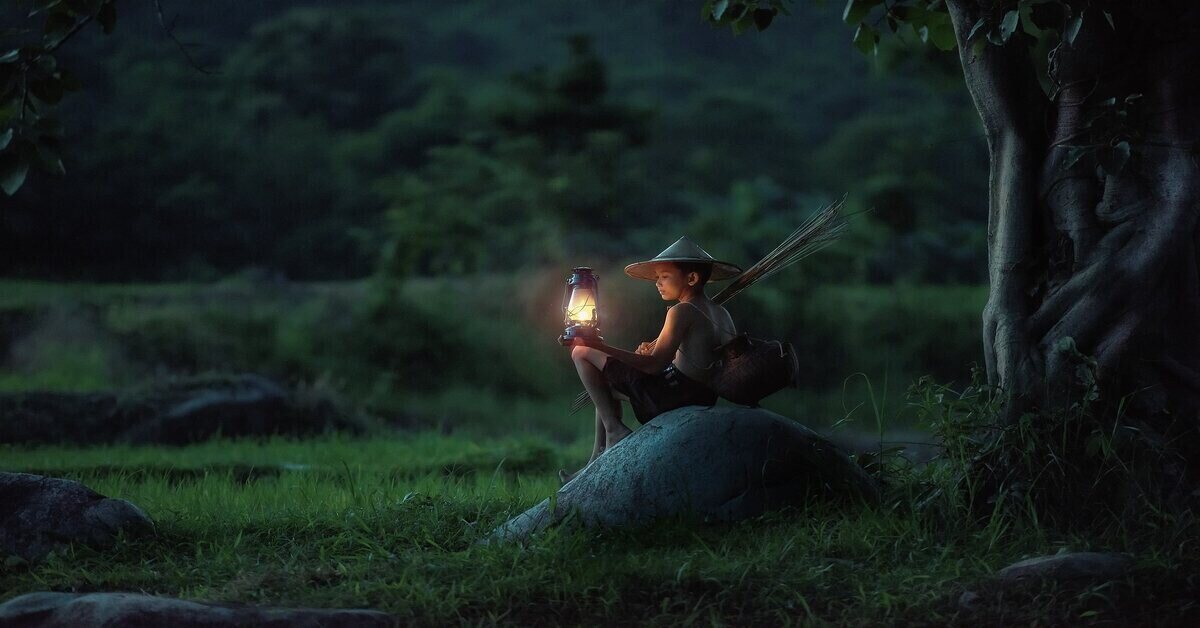 boy holding oil lantern