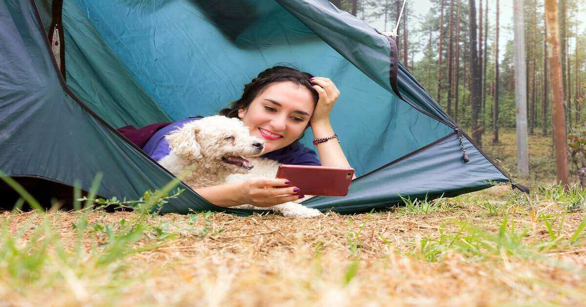 Woman with dog near tent