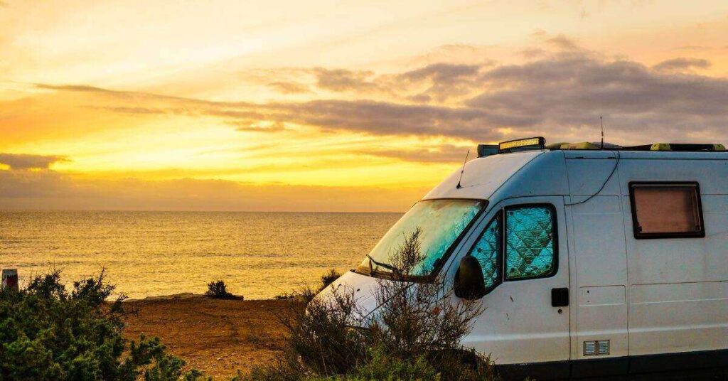 picture of campervan with sunset background