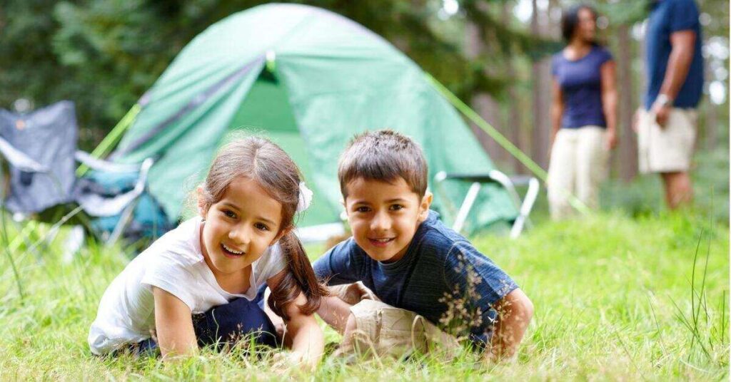 picture of kids posing near tent