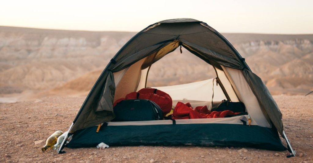 Tent in desert with items inside